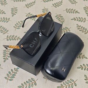 CHANEL Elegant Black Sunglasses with Gold Accents